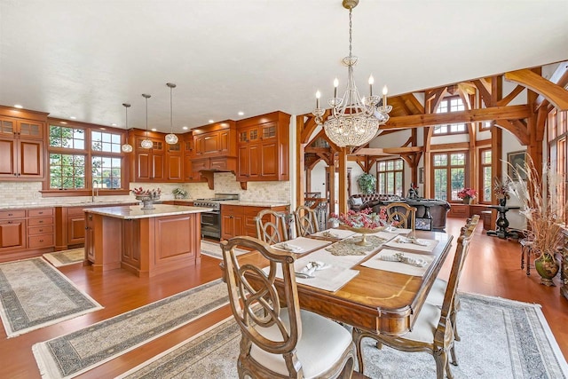 dining room with a chandelier, light hardwood / wood-style flooring, a wealth of natural light, and sink