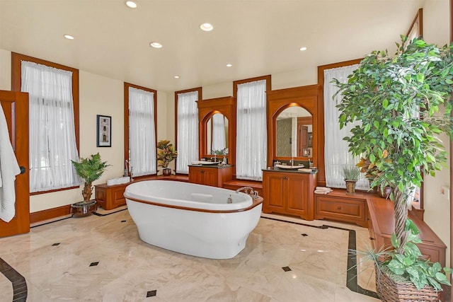 bathroom with a bathing tub and vanity