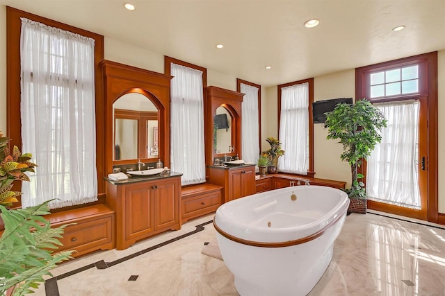 bathroom with vanity and a bathtub