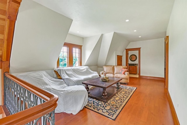 living room featuring light hardwood / wood-style flooring and vaulted ceiling