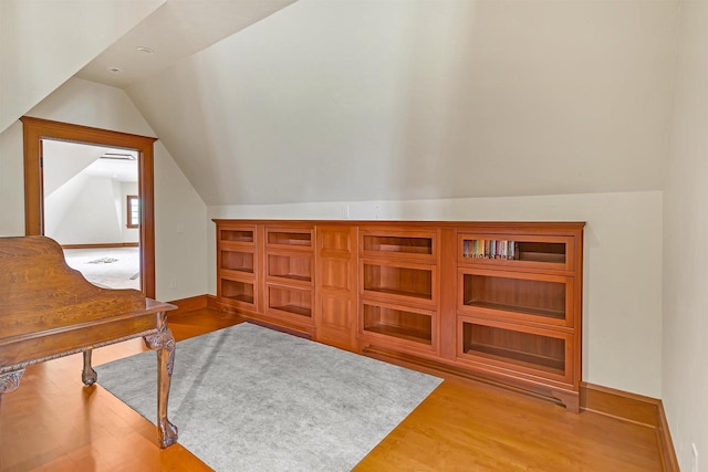 home office with light hardwood / wood-style flooring and vaulted ceiling