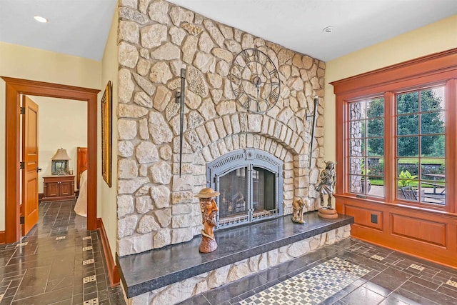 unfurnished living room with a stone fireplace