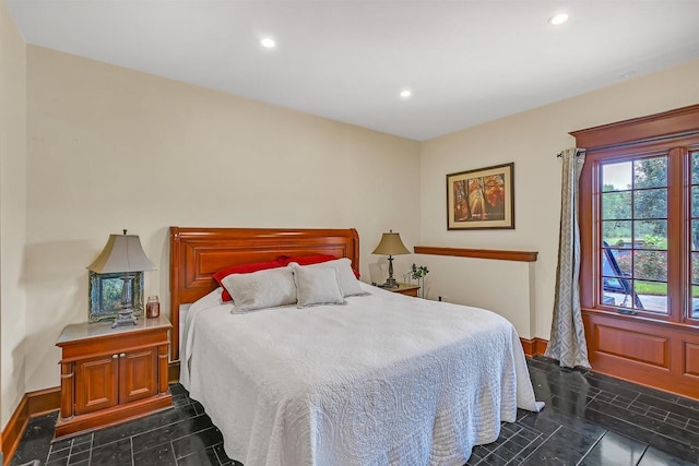 bedroom with dark tile patterned floors