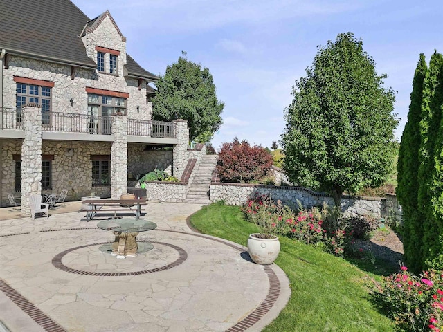 view of yard featuring a balcony and a patio