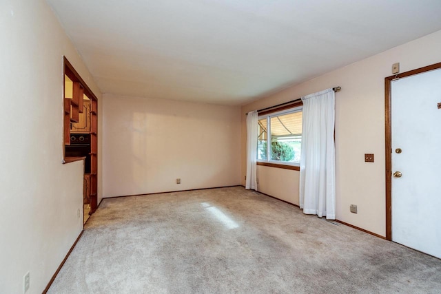 empty room featuring light carpet