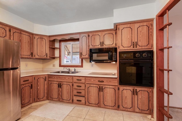 kitchen with light tile patterned floors, sink, and black appliances