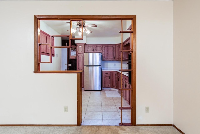 kitchen featuring stainless steel refrigerator, ceiling fan, and light colored carpet