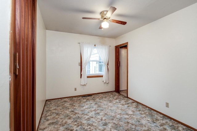 empty room with carpet flooring and ceiling fan