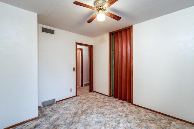 carpeted empty room with ceiling fan