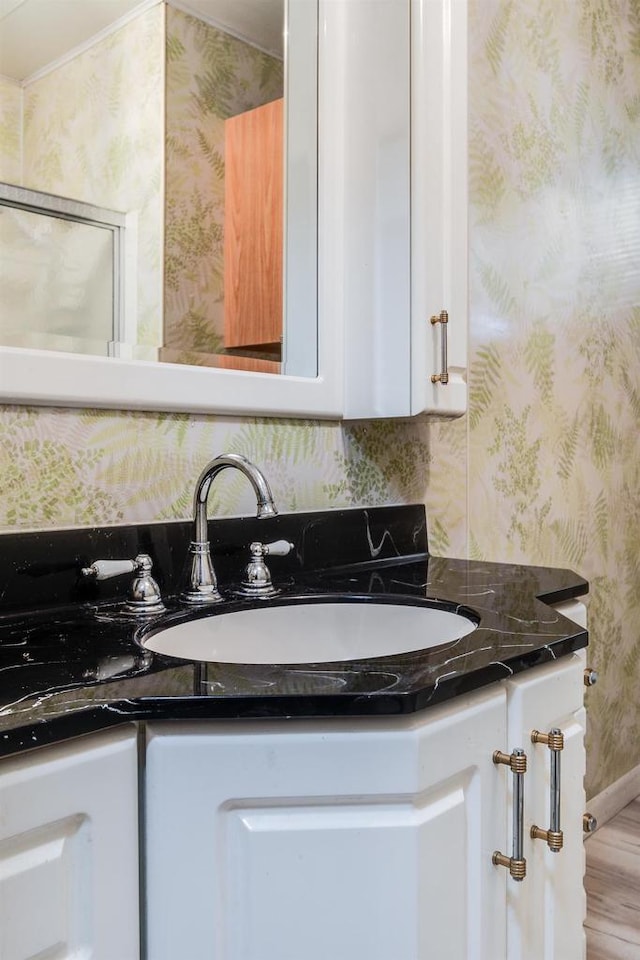 interior space featuring white cabinetry and sink