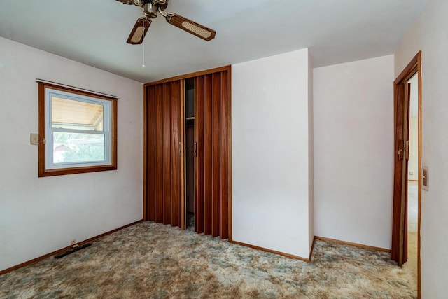 empty room featuring ceiling fan and light colored carpet