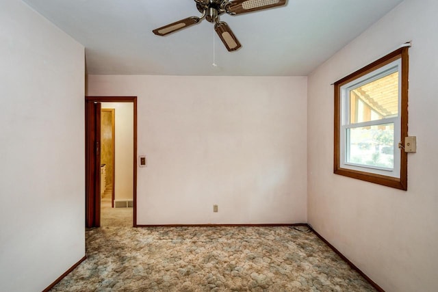 spare room featuring carpet floors and ceiling fan