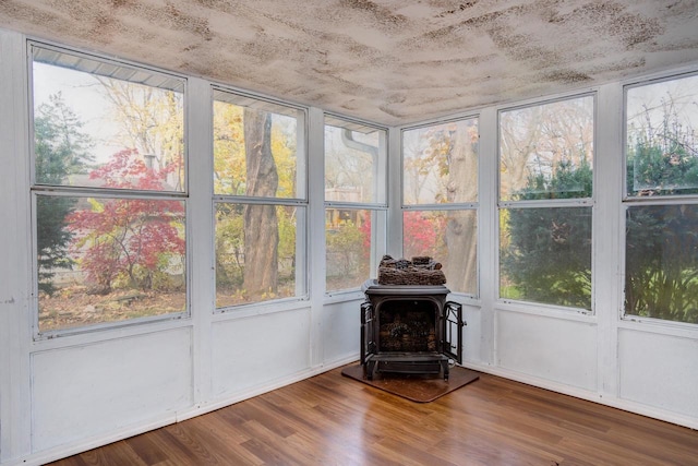 unfurnished sunroom with a wood stove