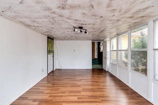 spare room with hardwood / wood-style flooring