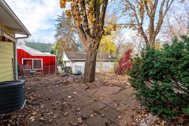 view of yard featuring cooling unit and an outbuilding