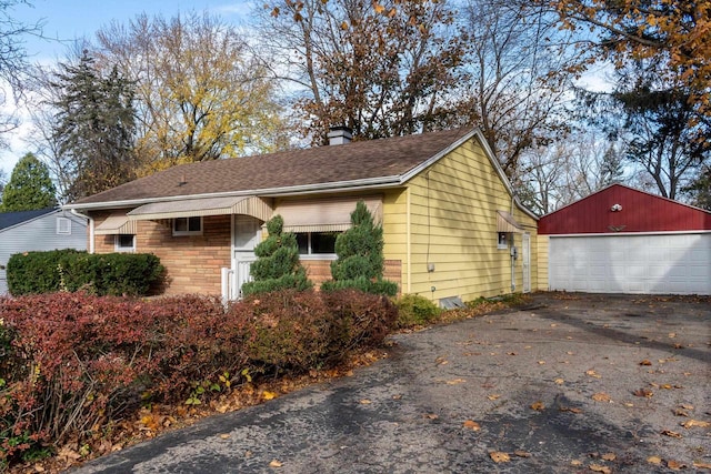 view of side of property featuring an outbuilding and a garage