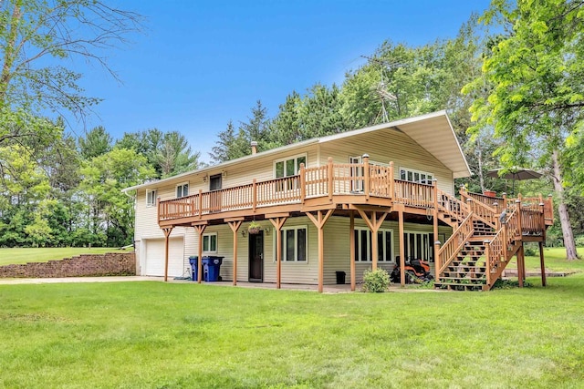 back of house featuring a wooden deck, a yard, and a garage