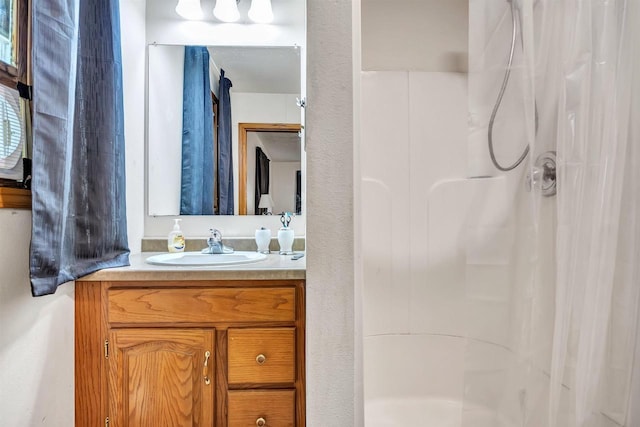 bathroom featuring vanity and curtained shower