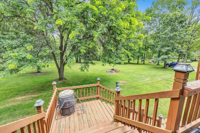 deck featuring a yard and a grill