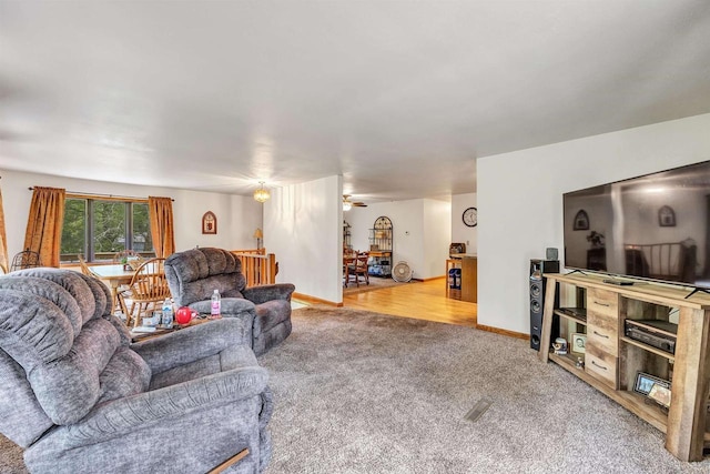 living room with carpet and ceiling fan