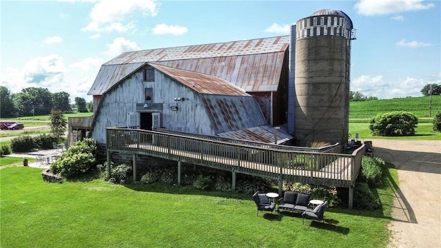 view of outbuilding featuring a yard and a rural view