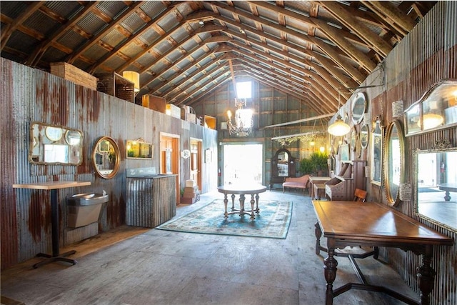 dining space with high vaulted ceiling and a notable chandelier