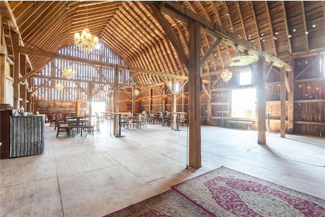 misc room with an inviting chandelier and high vaulted ceiling