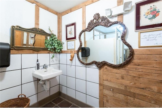 interior space with tile patterned flooring, tile walls, and sink