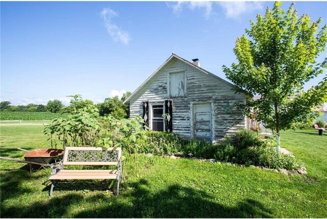 view of outdoor structure featuring a lawn