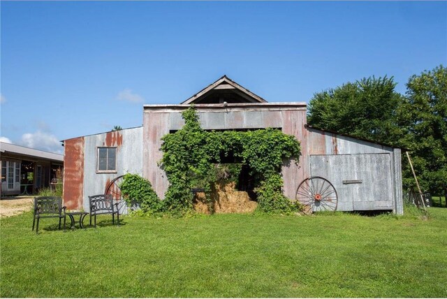 view of outbuilding with a lawn