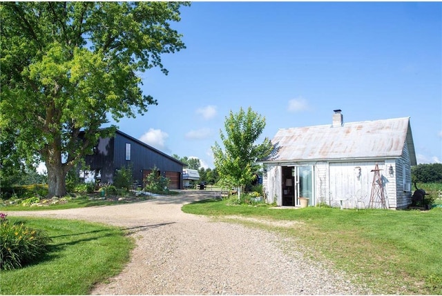 exterior space featuring an outbuilding and a lawn