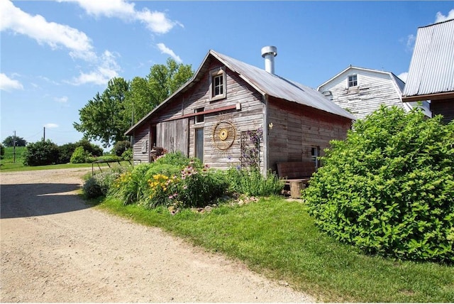 view of property exterior with an outdoor structure