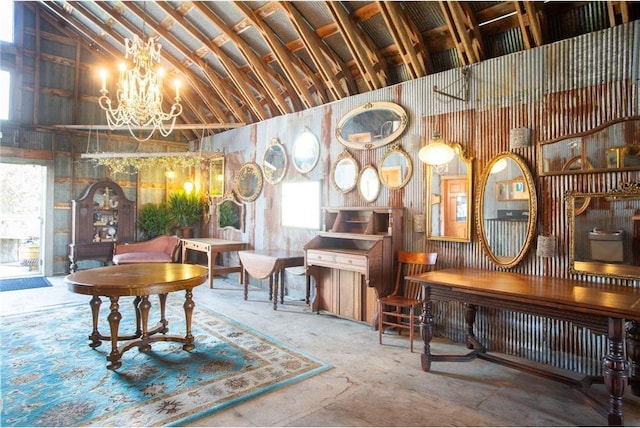 misc room featuring a chandelier, a healthy amount of sunlight, and high vaulted ceiling