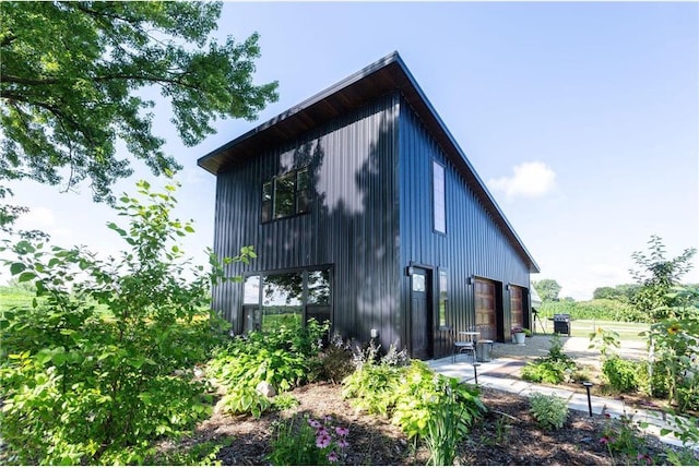 view of side of home featuring a garage and an outbuilding