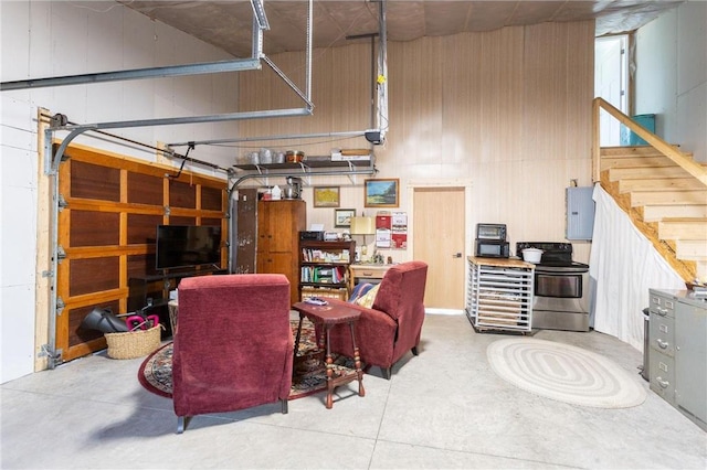 living room featuring wood walls and concrete flooring