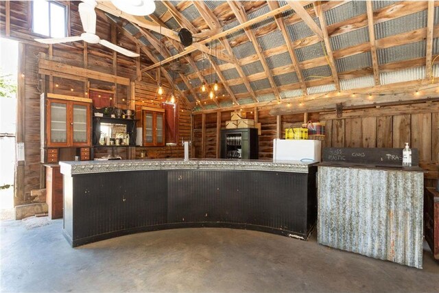 kitchen with kitchen peninsula and concrete flooring