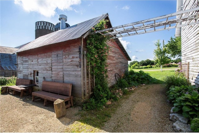 view of side of home with an outdoor structure