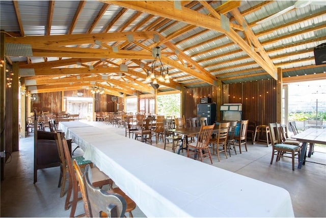 dining area with high vaulted ceiling, plenty of natural light, concrete floors, and beamed ceiling