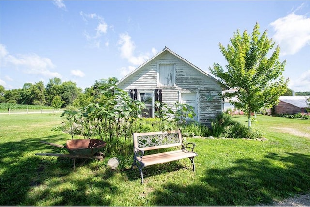 rear view of property with a lawn