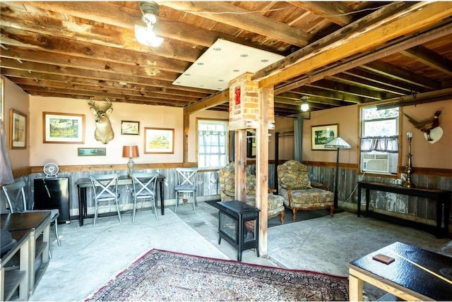 interior space with concrete flooring and wood walls