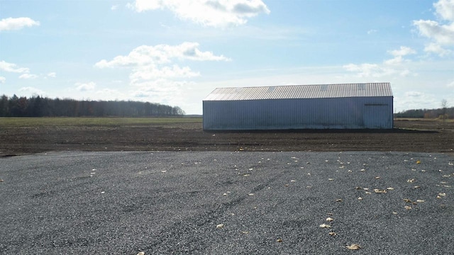 view of side of home featuring an outdoor structure