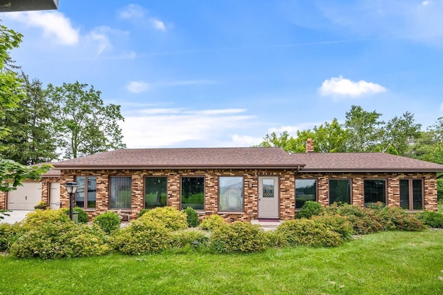 view of front facade with a front lawn and a garage