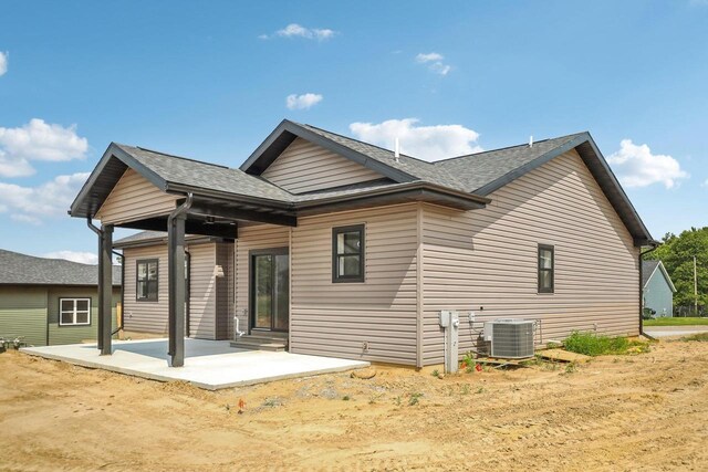 rear view of house featuring a patio and central air condition unit