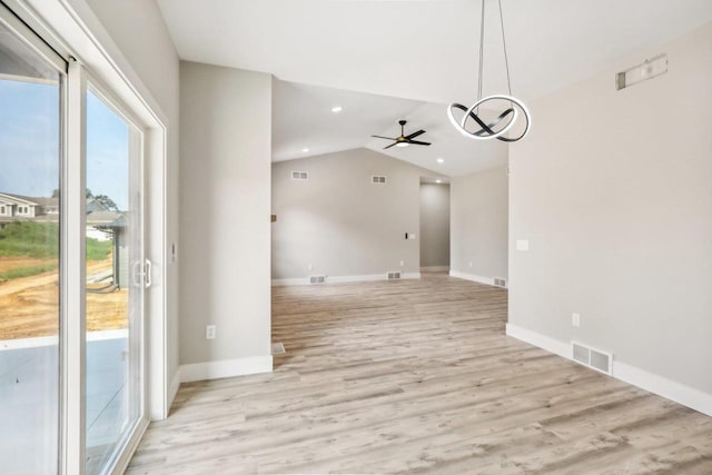 unfurnished dining area featuring light hardwood / wood-style floors, lofted ceiling, and ceiling fan