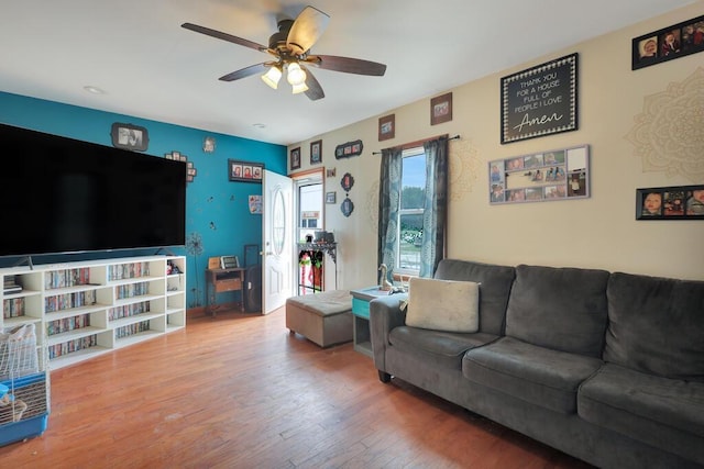 living room with ceiling fan and hardwood / wood-style floors