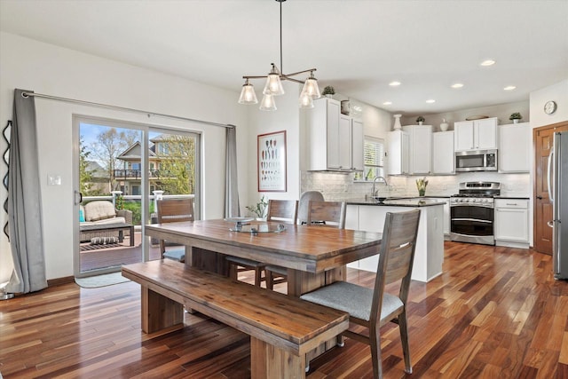 dining space featuring dark wood-type flooring and sink