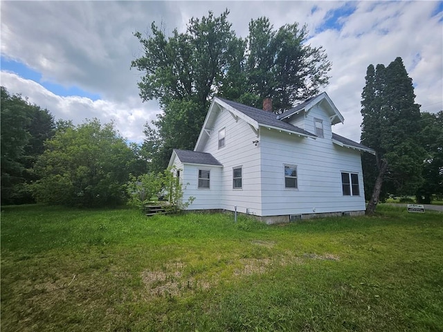 view of side of property with a lawn