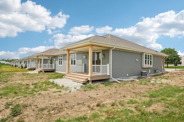 502 Hickory Hollow Rd Unit 0101, Waterford, WI 53185 - back of house with central AC, a wooden deck, and a shingled roof