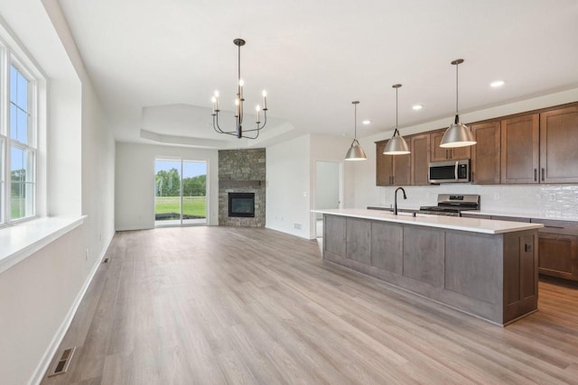 502 Hickory Hollow Rd Unit 0101, Waterford, WI 53185 - kitchen with appliances with stainless steel finishes, light countertops, light wood-style floors, a kitchen island with sink, and recessed lighting