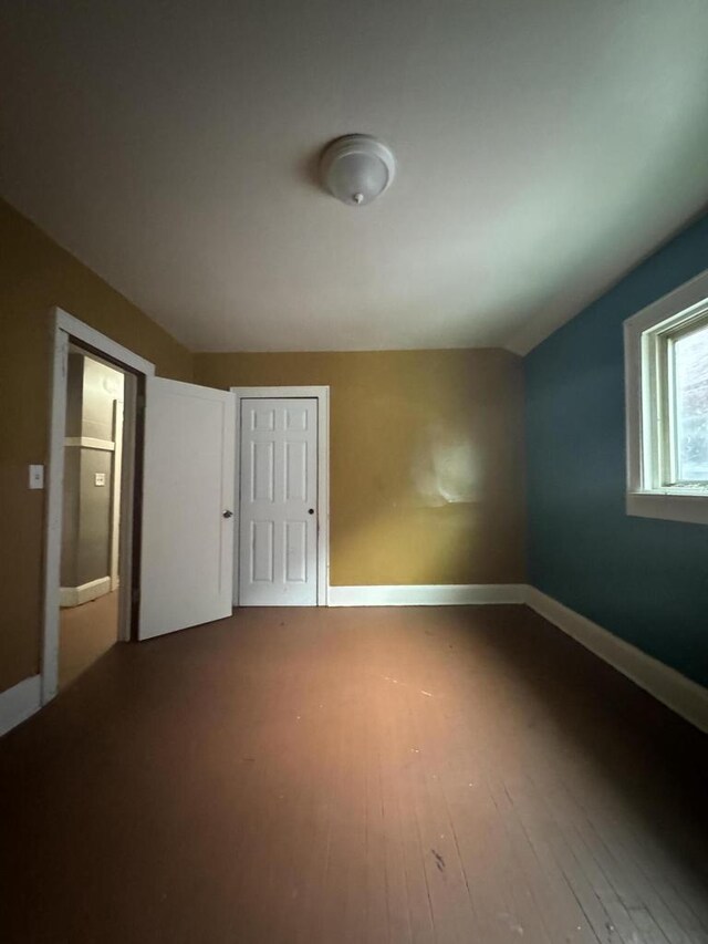 spare room with wood-type flooring